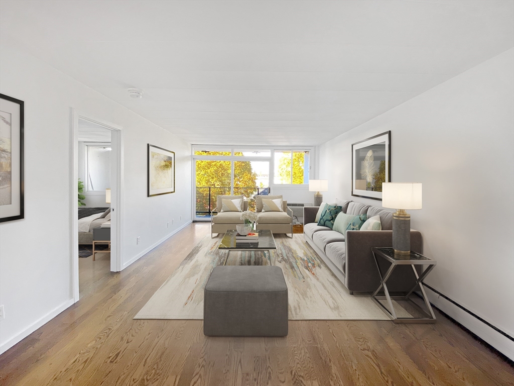 a living room with furniture window and wooden floor