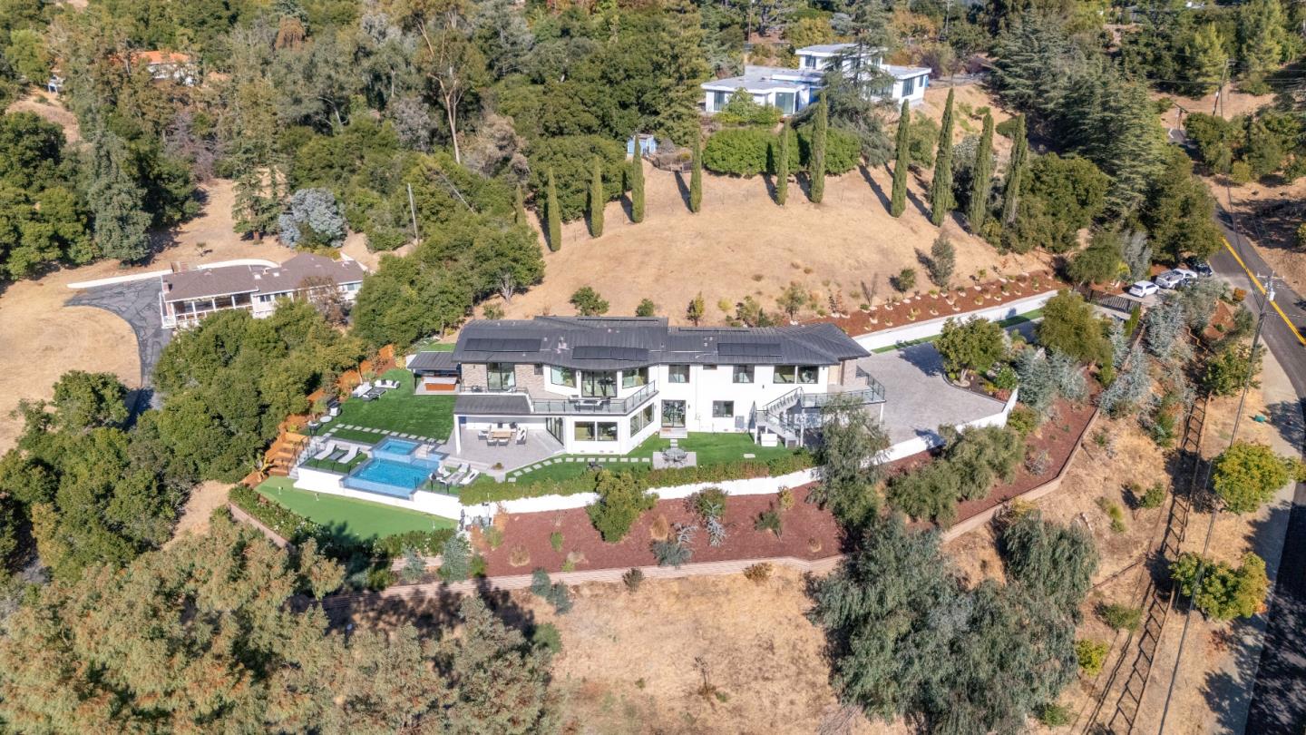 an aerial view of a house with yard swimming pool and outdoor seating