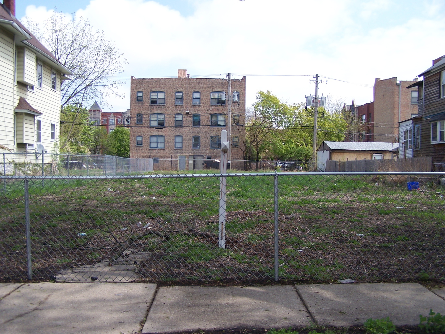 a view of a brick house next to a yard