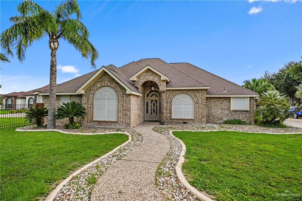 Single story home featuring a front lawn