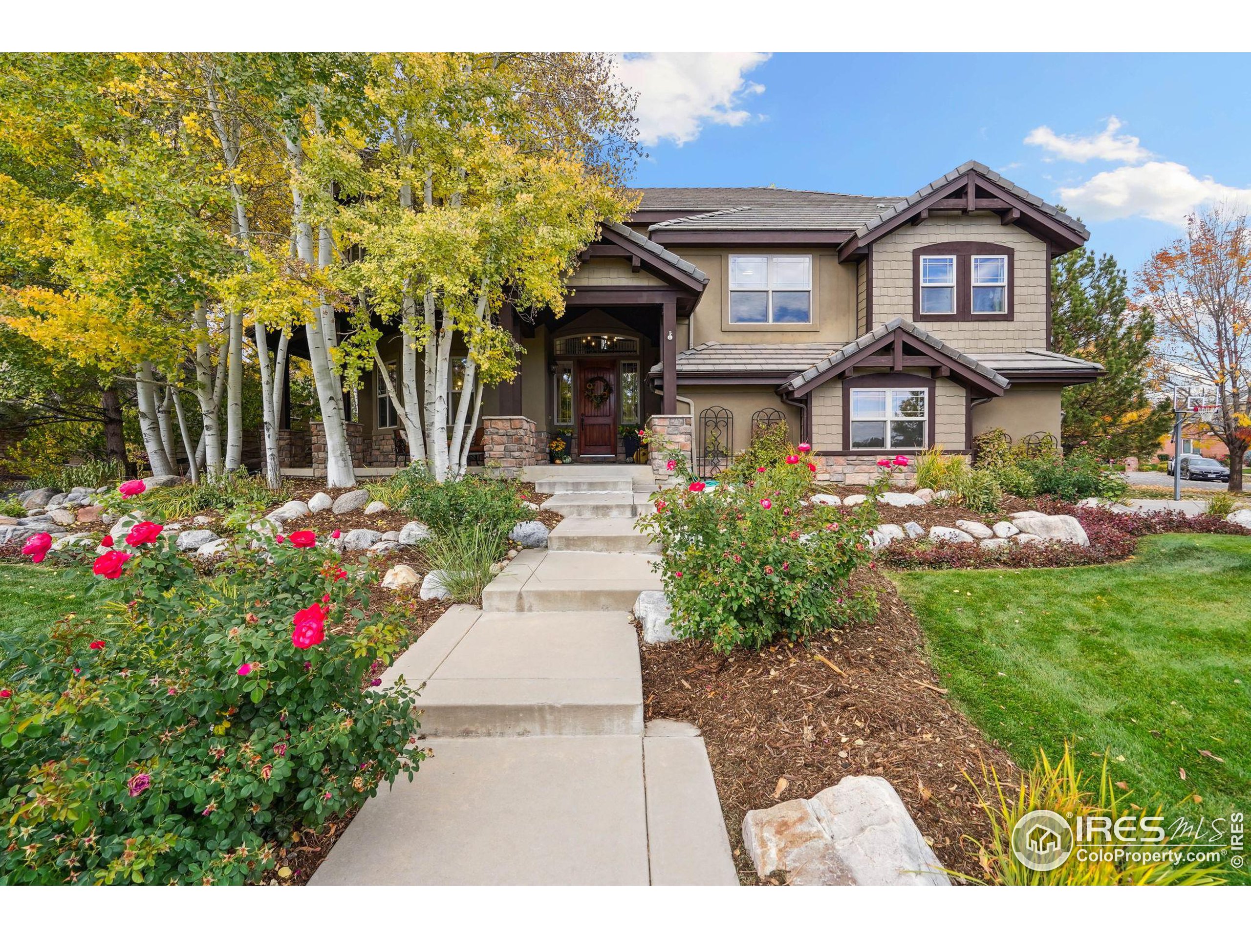 a view of a big house with a big yard and potted plants