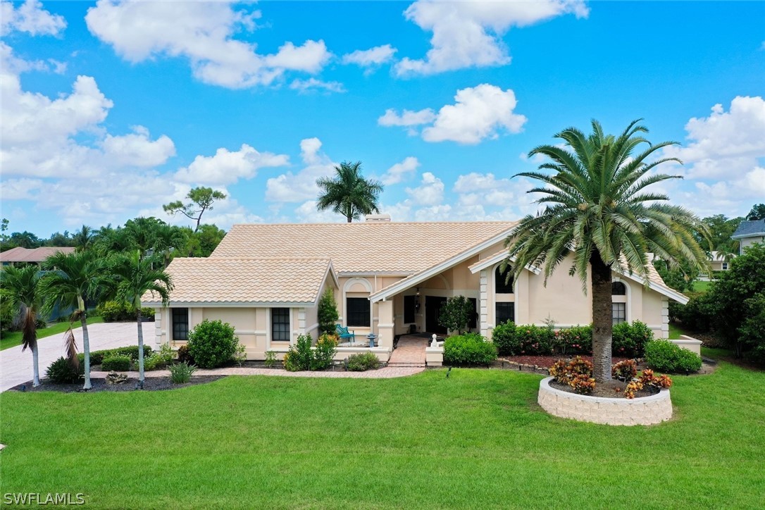 a front view of a house with a garden and patio