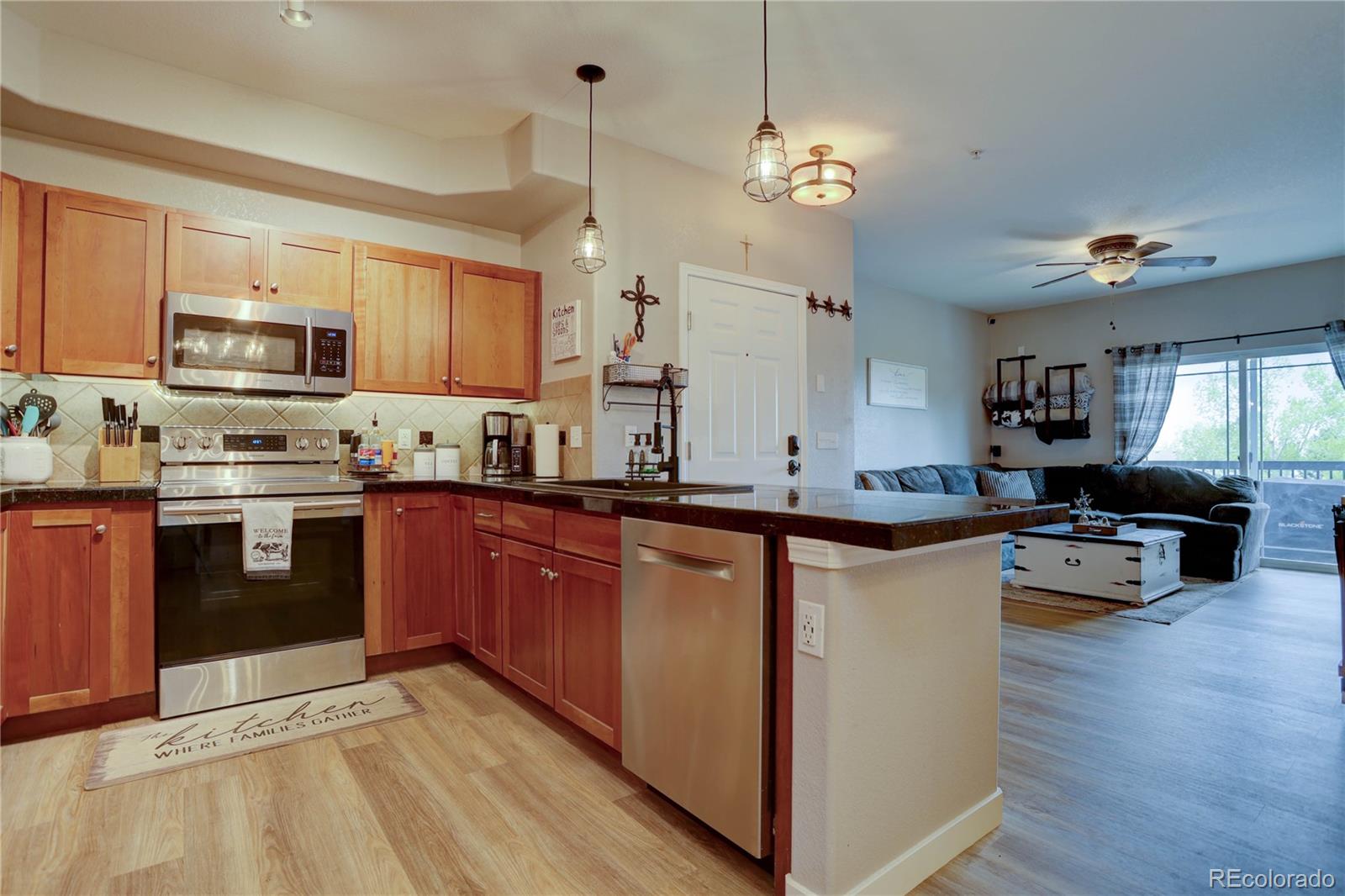 a large kitchen with stainless steel appliances granite countertop a stove and a sink