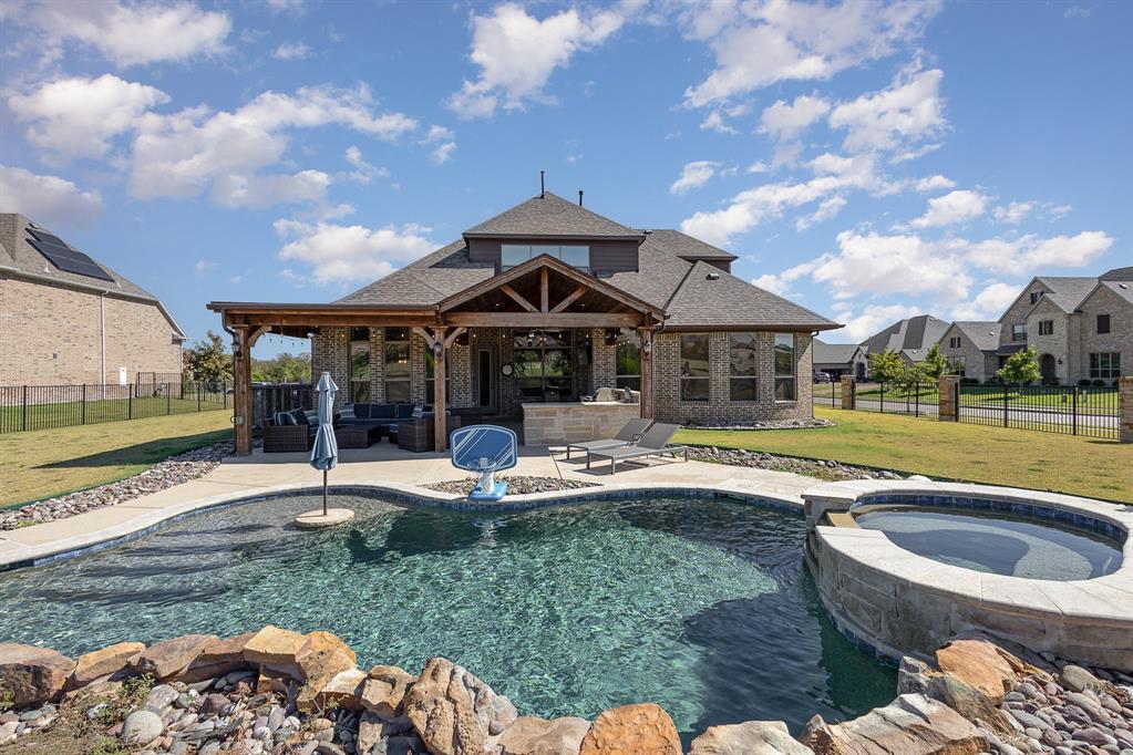 a view of a house with backyard and sitting area