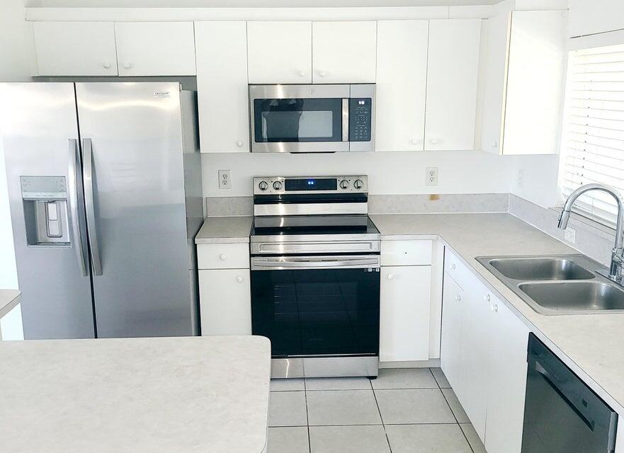 a kitchen with a refrigerator stove and microwave