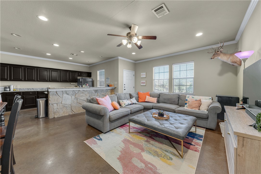 a living room with lots of furniture and kitchen view