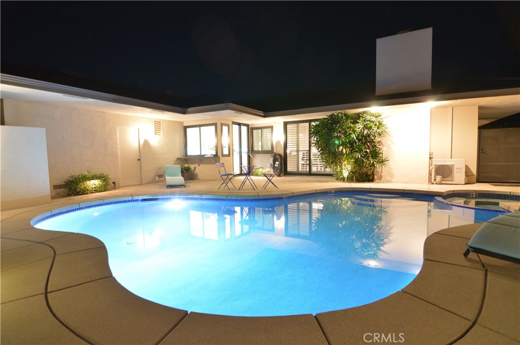 a view of a swimming pool with a lounge chairs