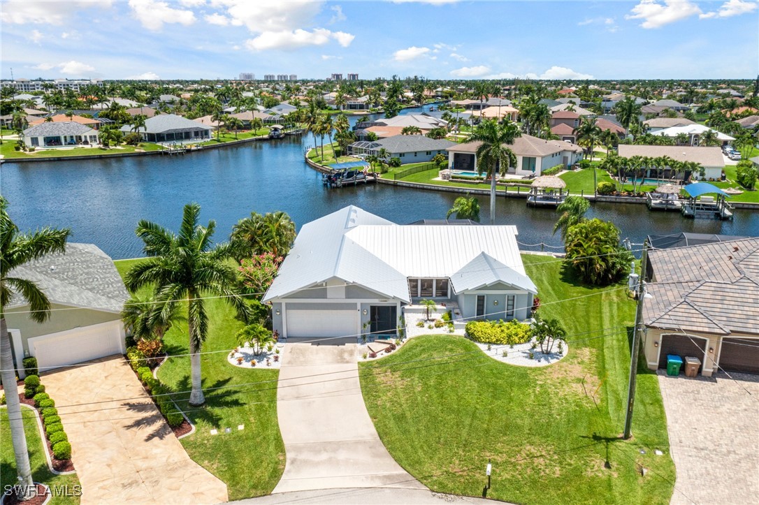 an aerial view of a house with a garden and lake view