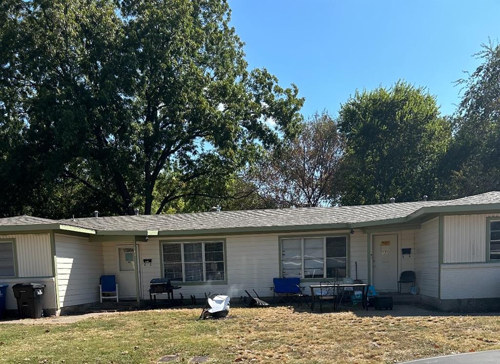 a backyard of a house with table and chairs