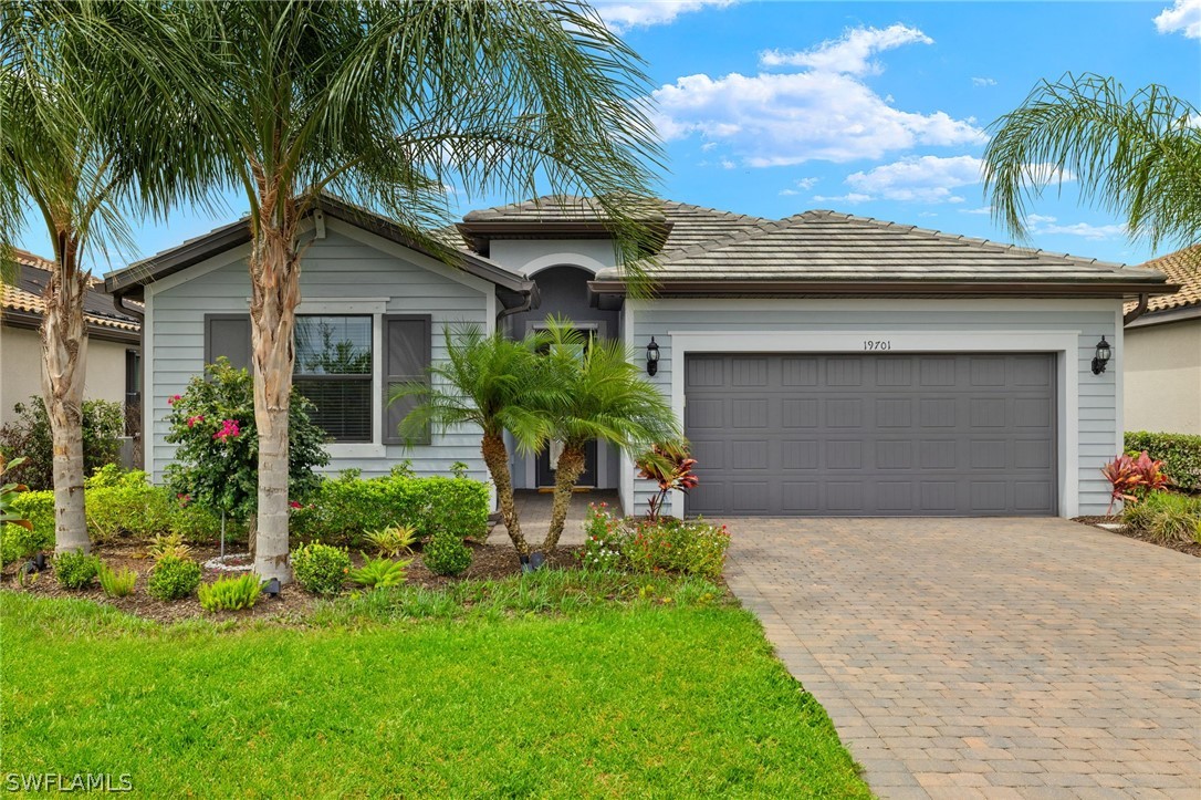 a front view of house with yard and green space