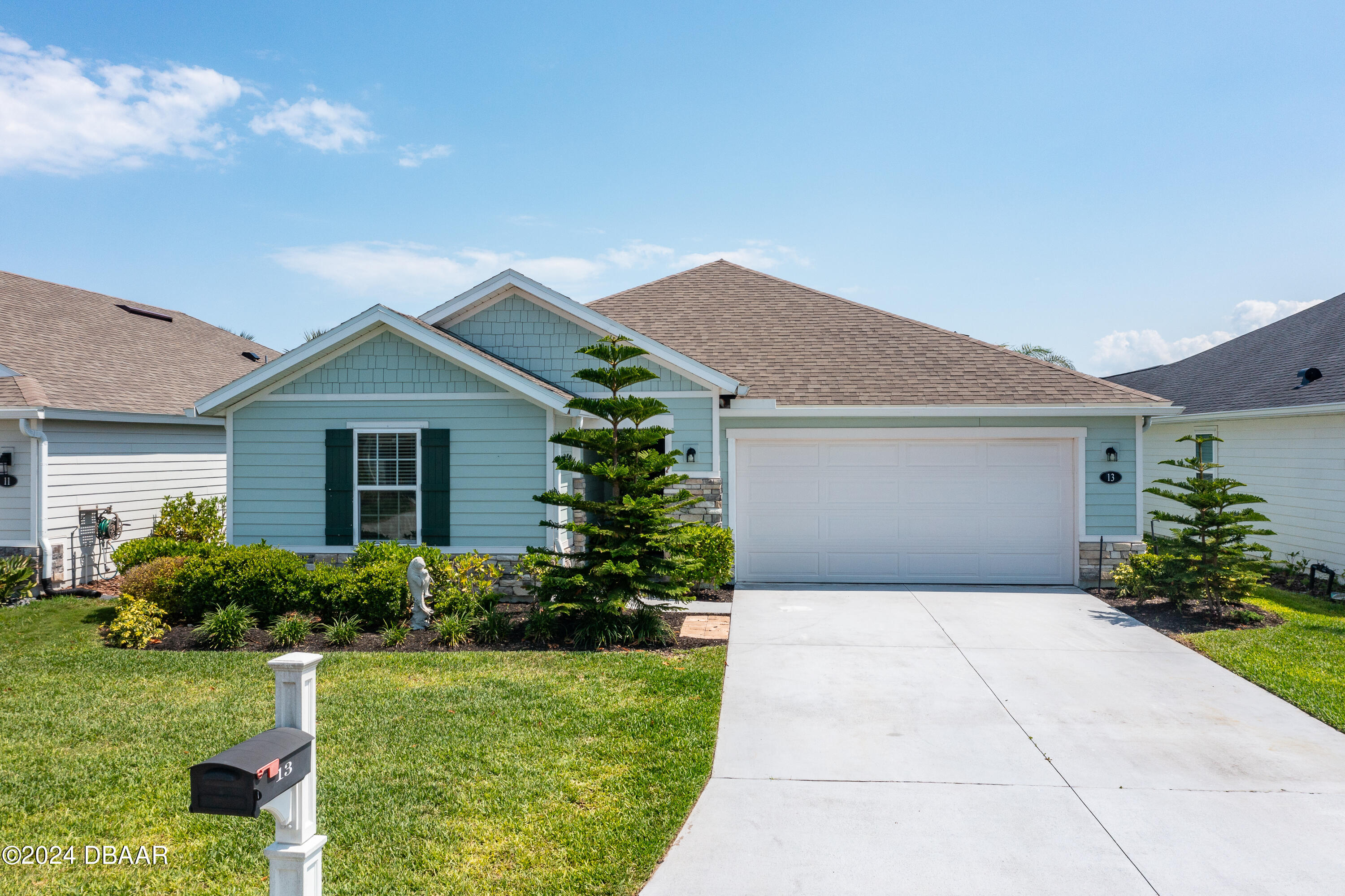 a front view of house with yard and green space