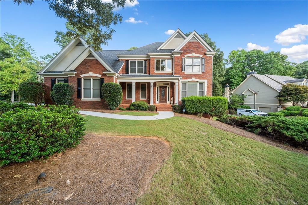 a front view of a house with a yard