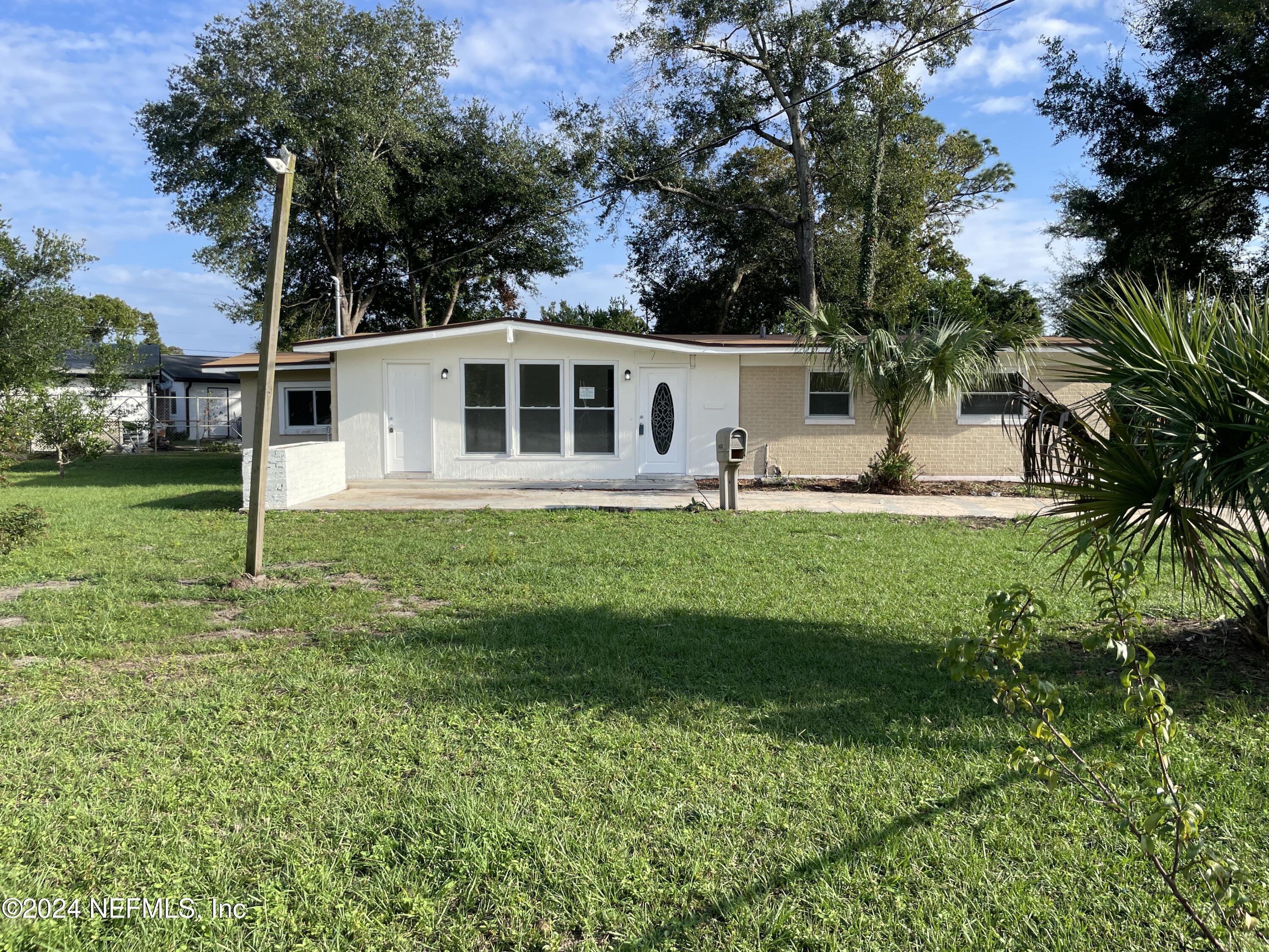 a front view of house with yard and green space