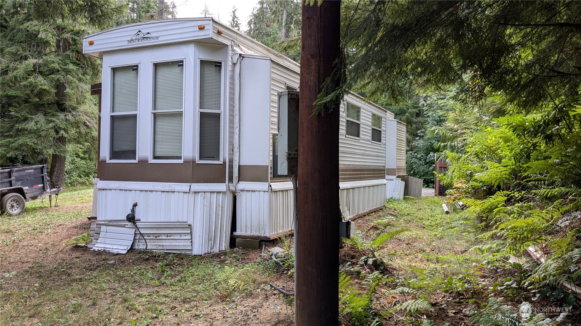 a view of a house with a small yard and wooden fence