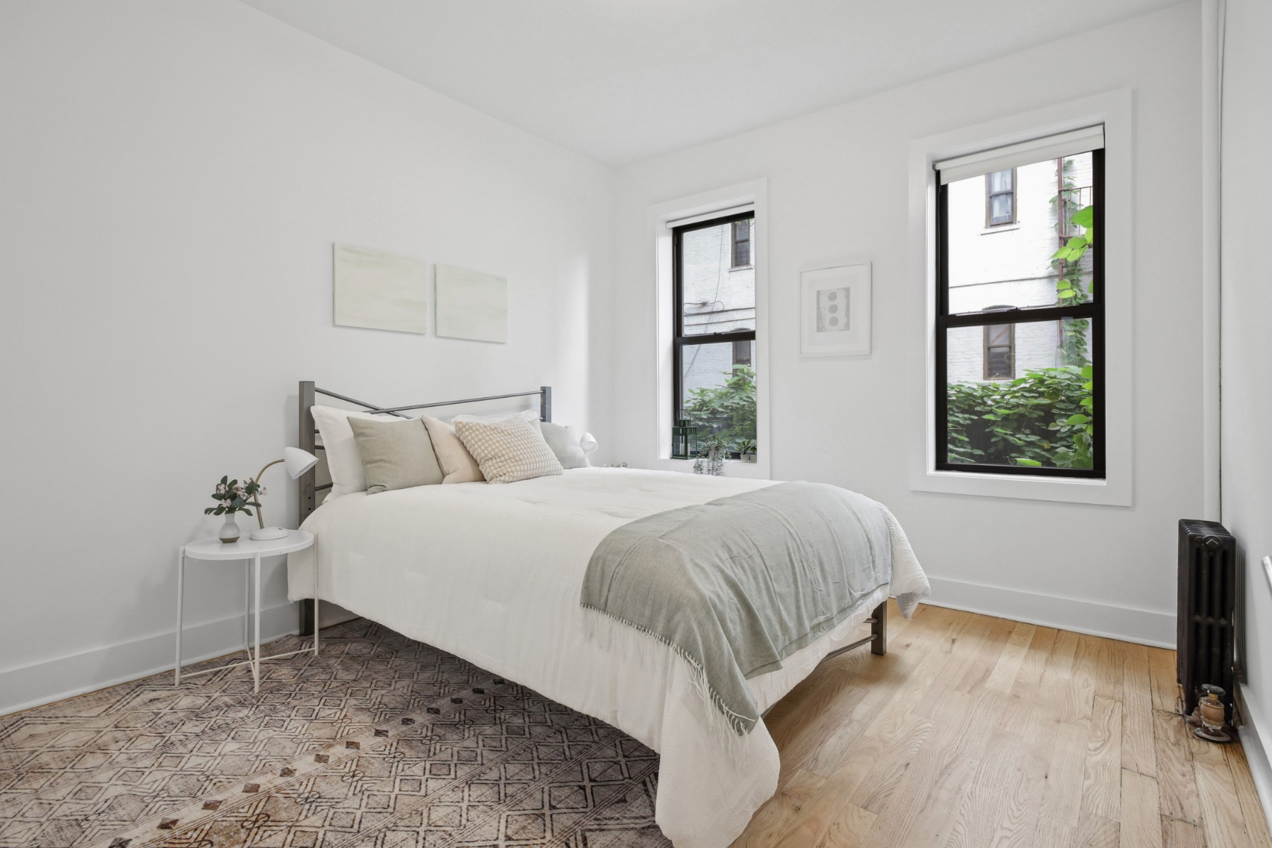 a bedroom with a bed table and window