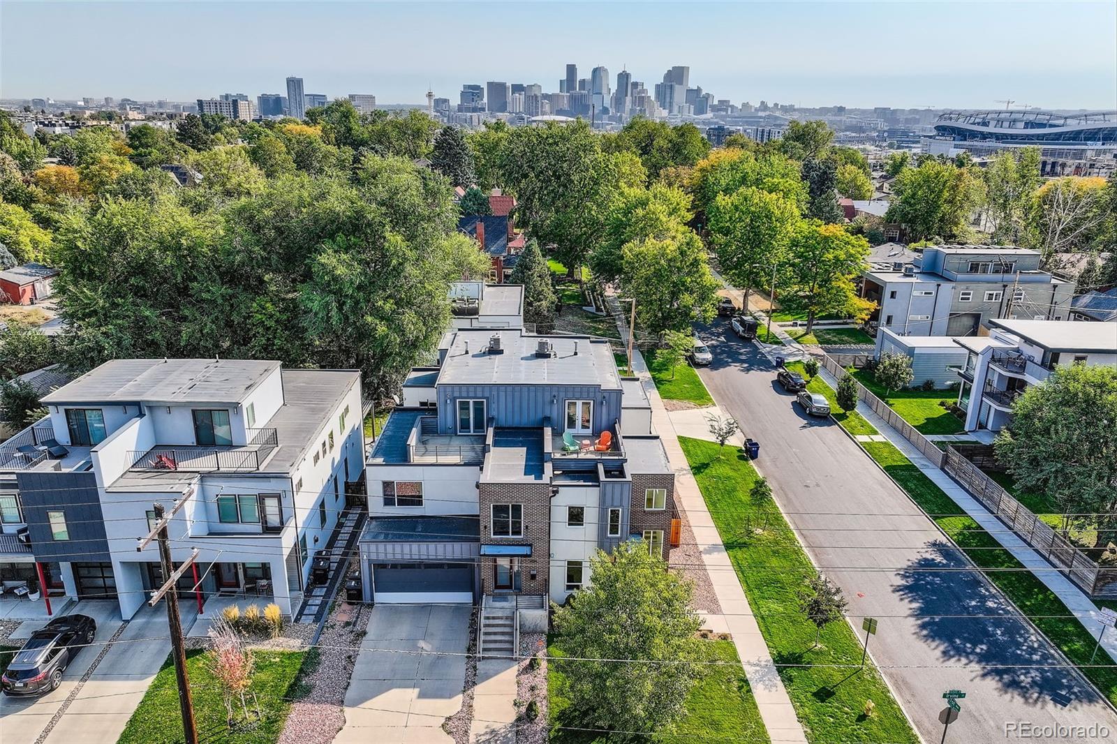 an aerial view of multiple houses with a yard