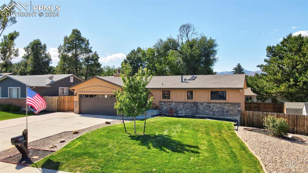 a front view of house with yard and green space