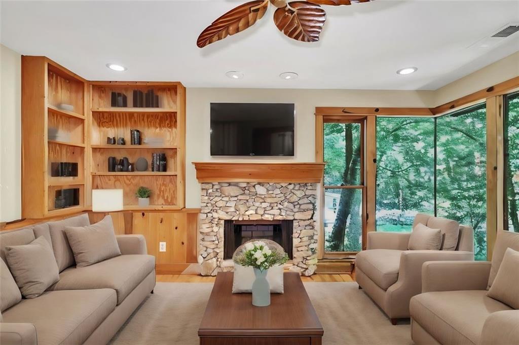 a living room with furniture fireplace and flat screen tv