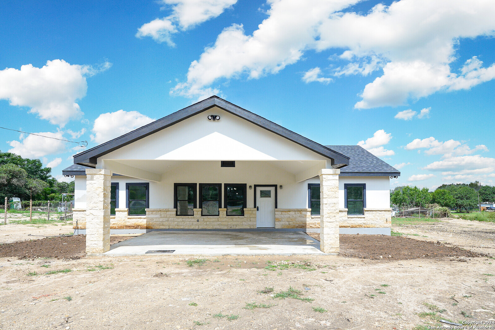 a front view of a house with a yard