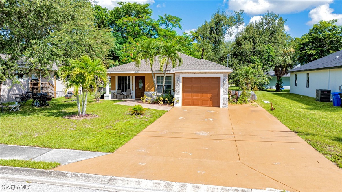 a front view of house with yard and green space