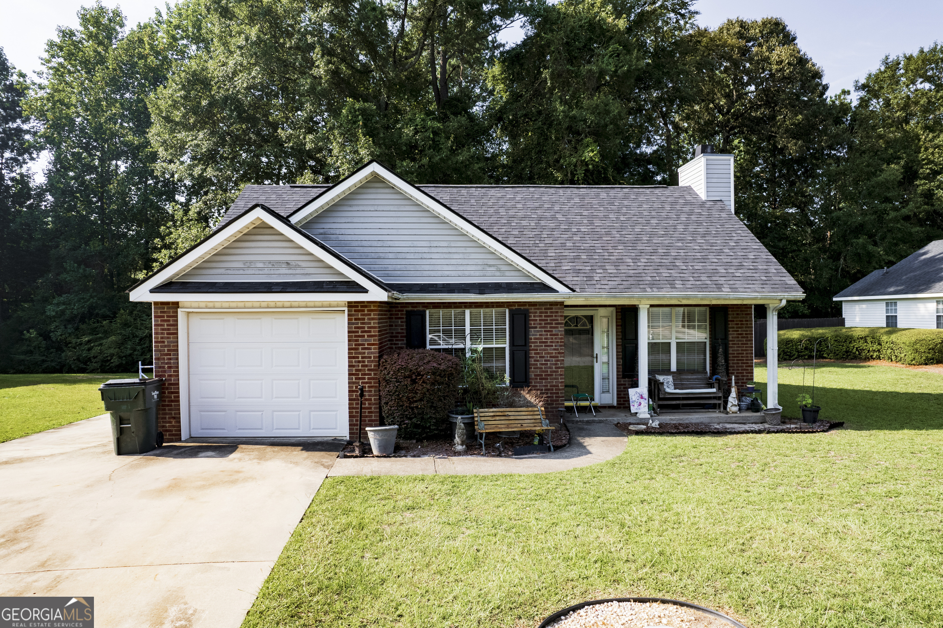 a front view of a house with a yard patio and fire pit