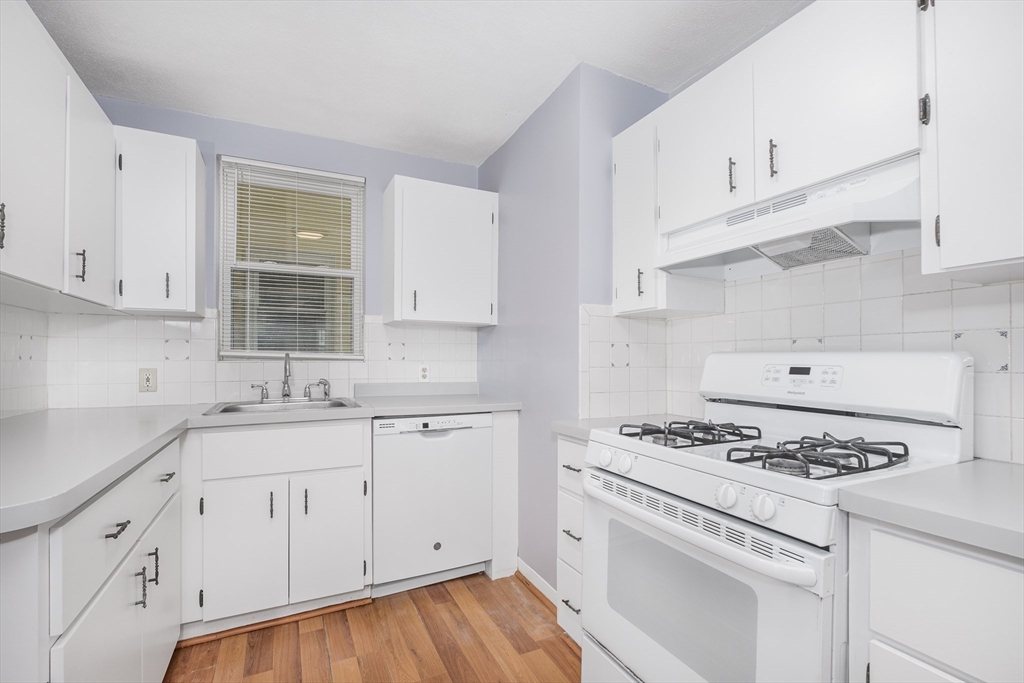 a kitchen with granite countertop cabinets and white appliances