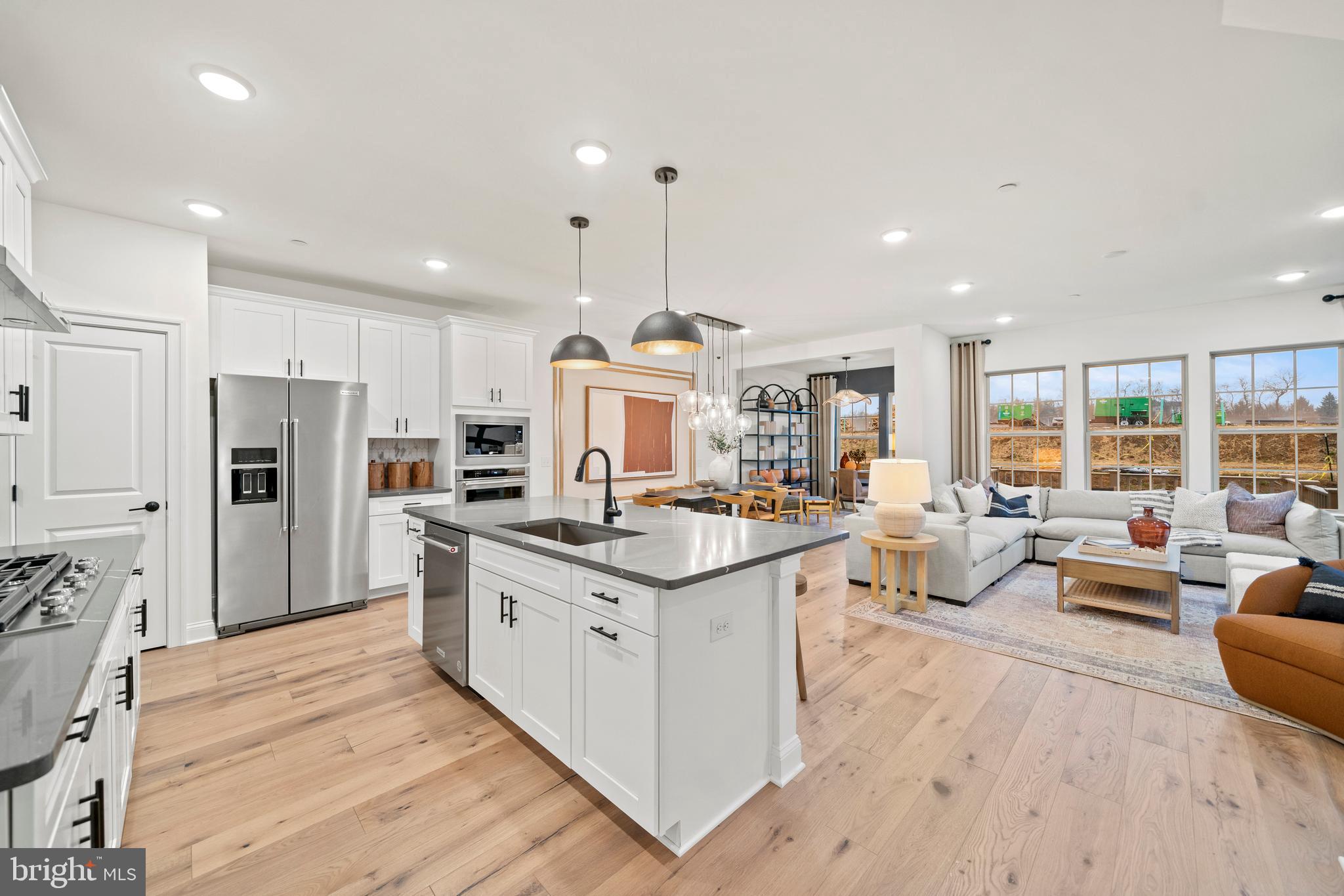 a kitchen with stainless steel appliances kitchen island granite countertop a stove and a refrigerator