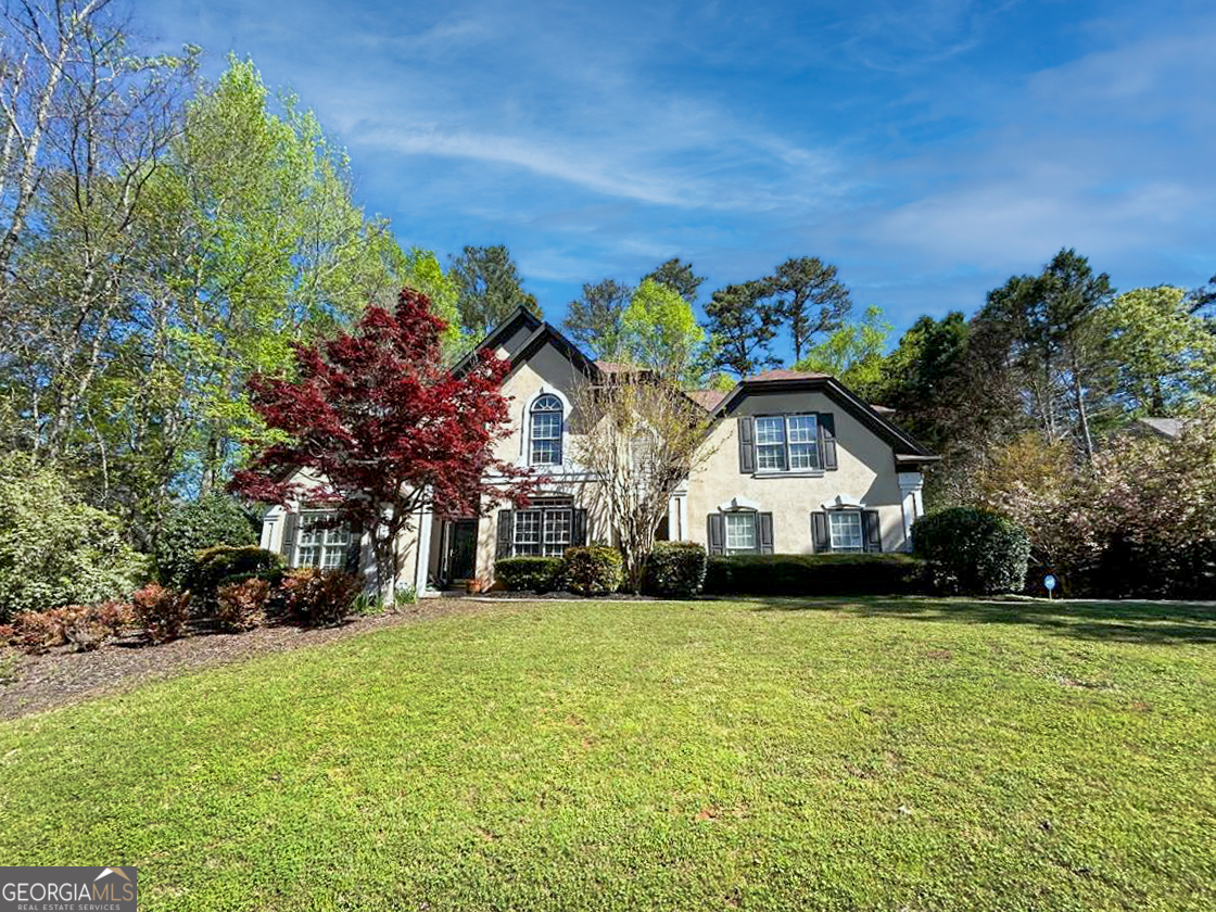 a front view of a house with a garden