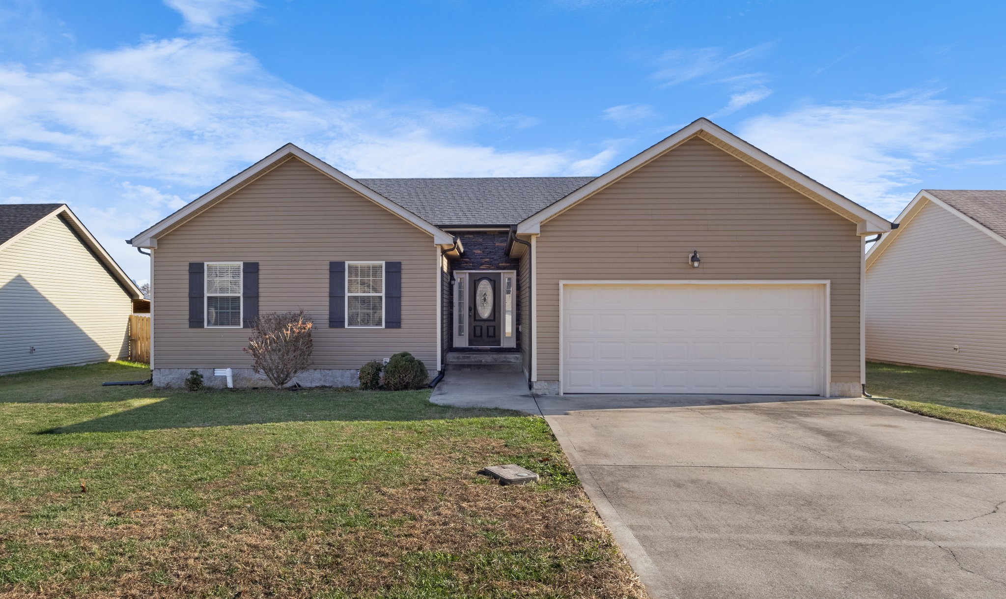 a front view of a house with a yard and garage