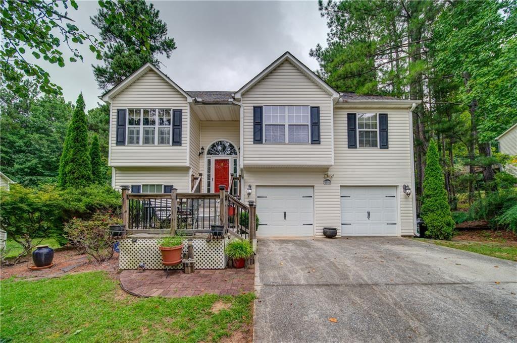 a front view of house with yard outdoor seating and garage