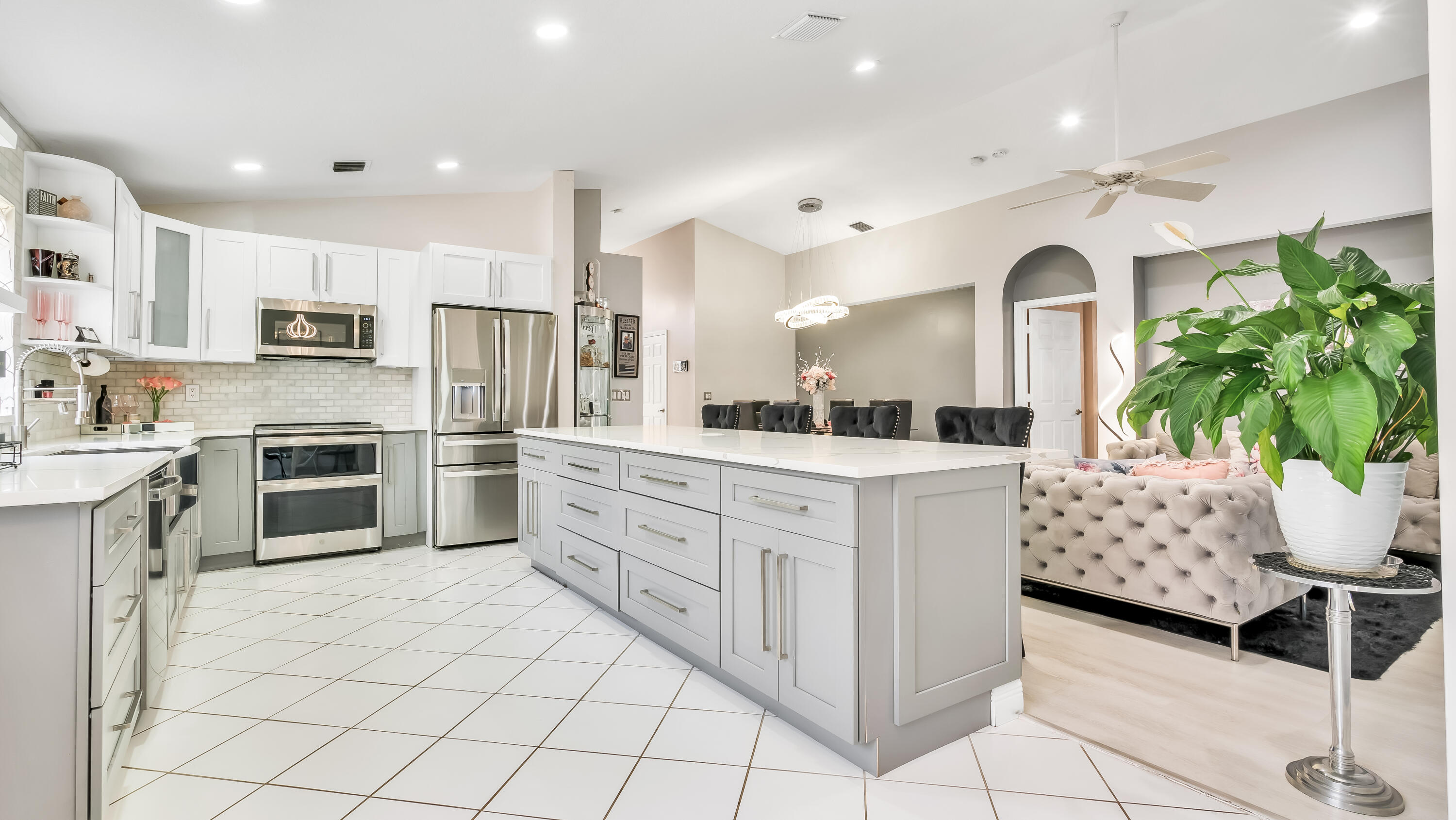 a kitchen with white cabinets and stainless steel appliances