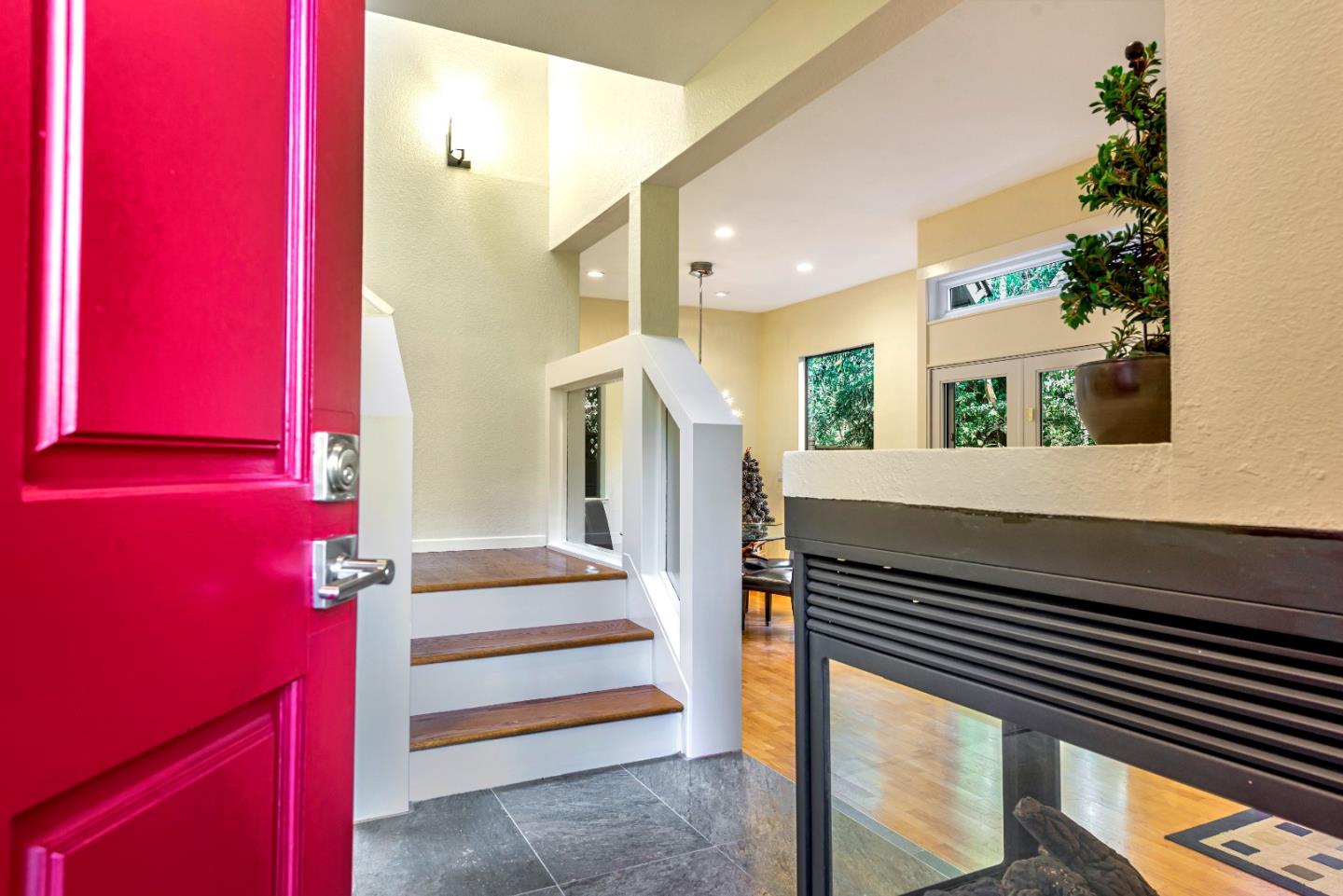 a view of entryway and hall with wooden floor