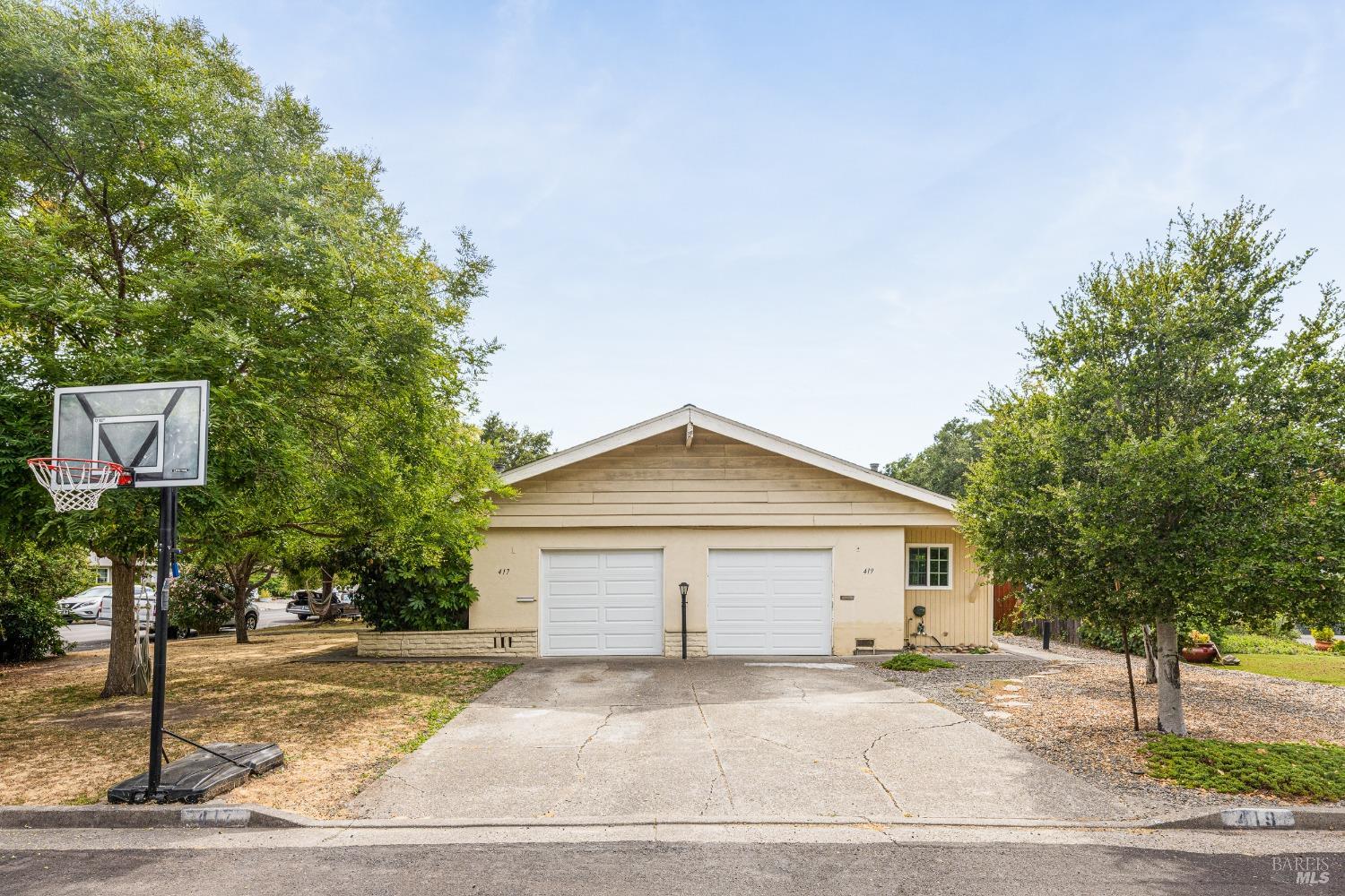 a view of a house and a yard and garage