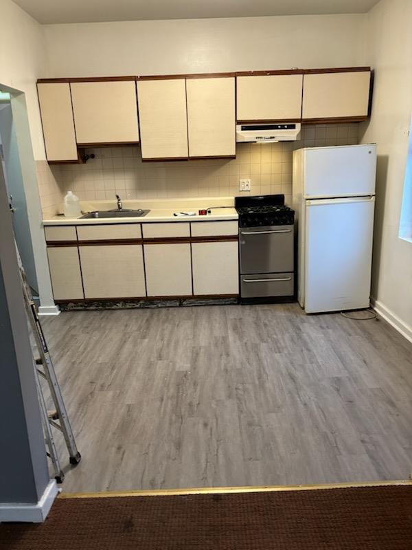 a kitchen with a refrigerator and a stove