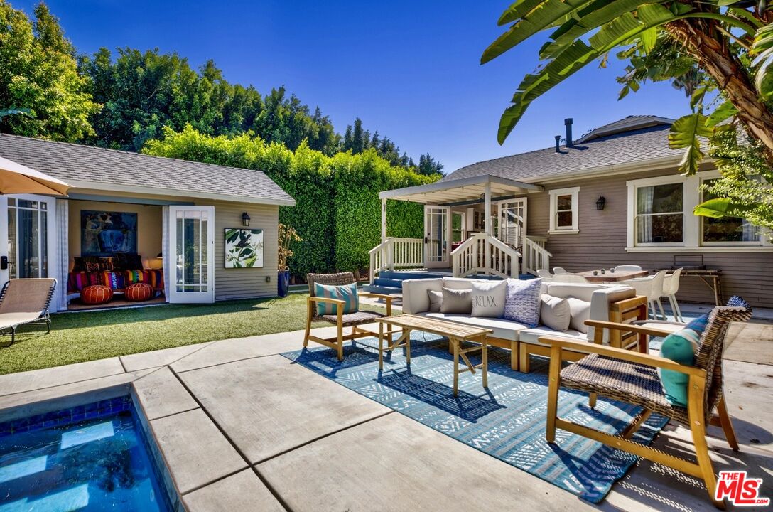 a view of a house with a backyard and sitting area