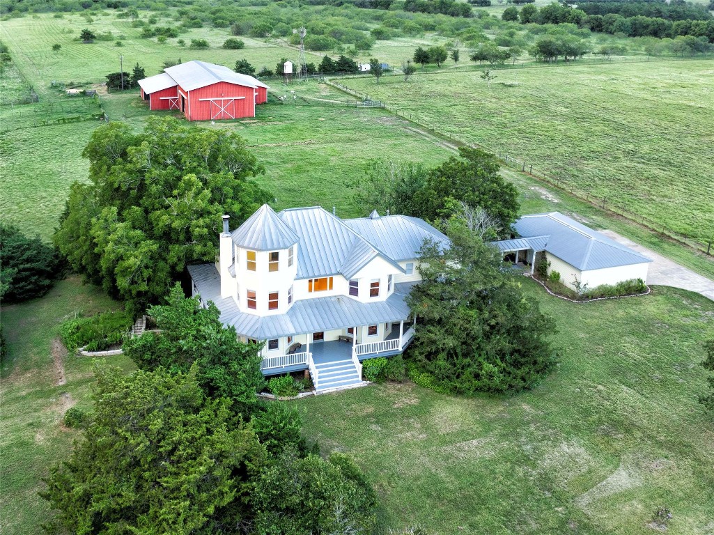 an aerial view of a house with pool yard and outdoor seating