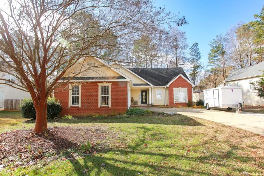 a front view of house with yard and trees around