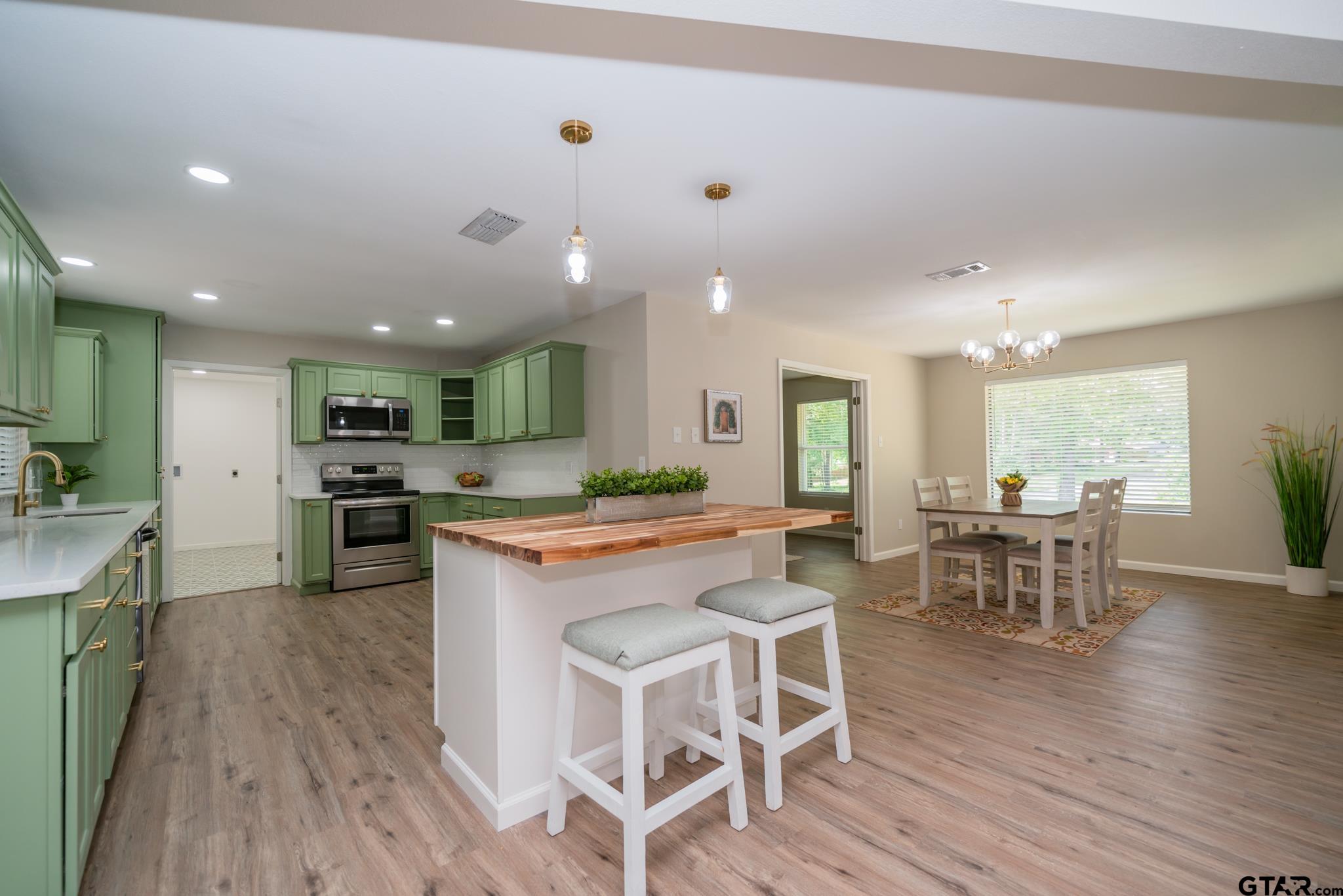 a large kitchen with a table and chairs in it