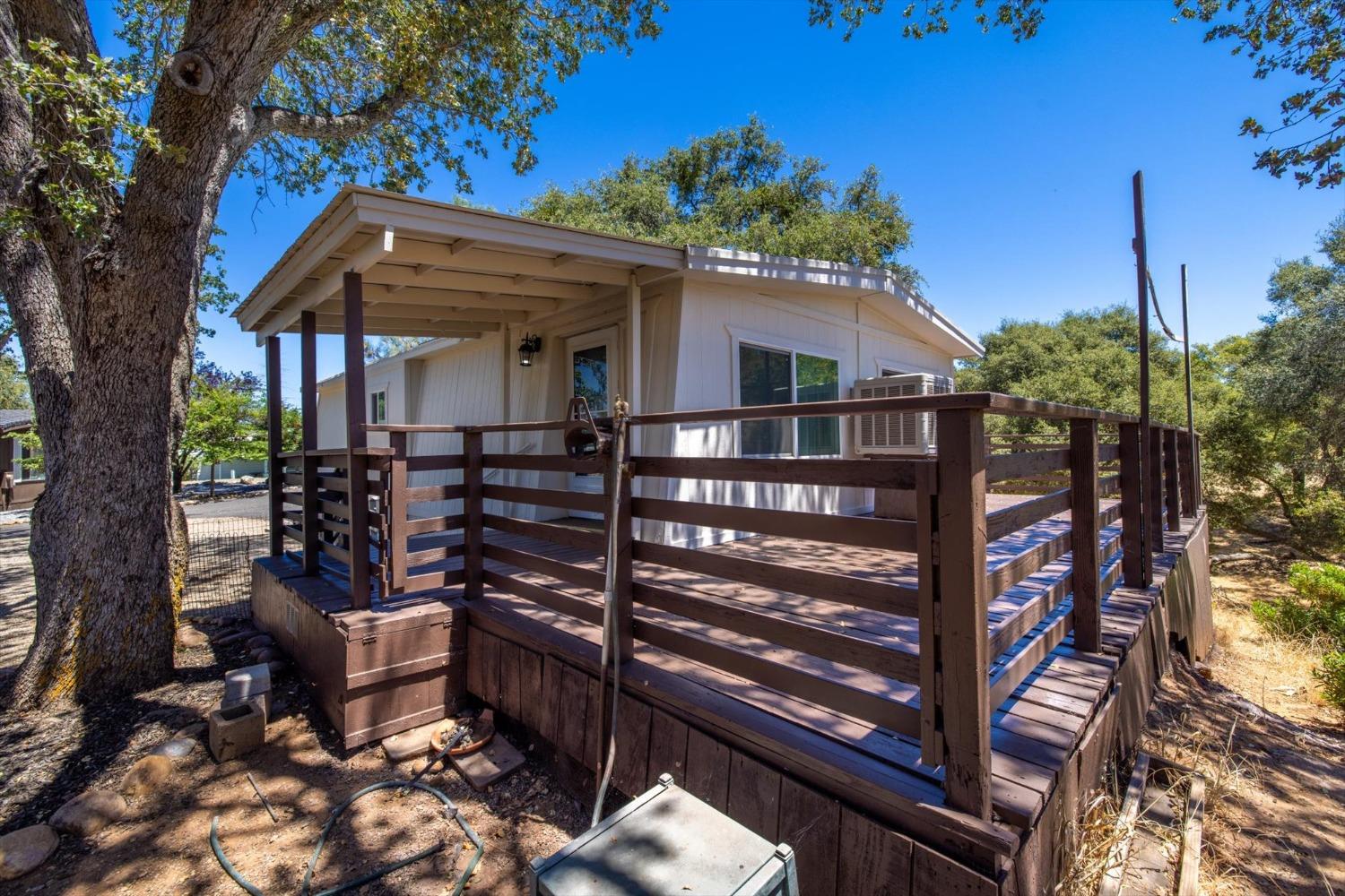 a front view of a house with outdoor seating