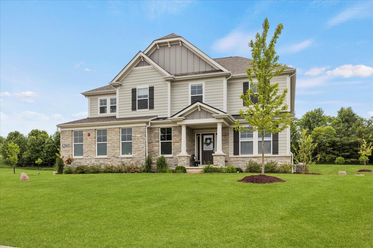 a front view of a house with a garden