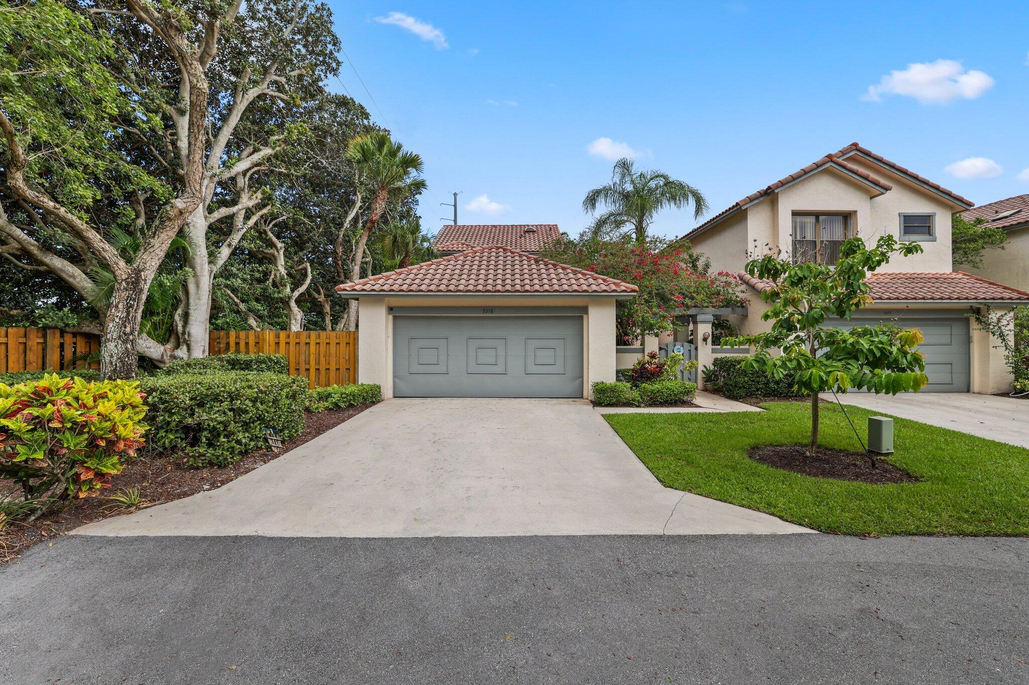 a front view of a house with a yard and a garage