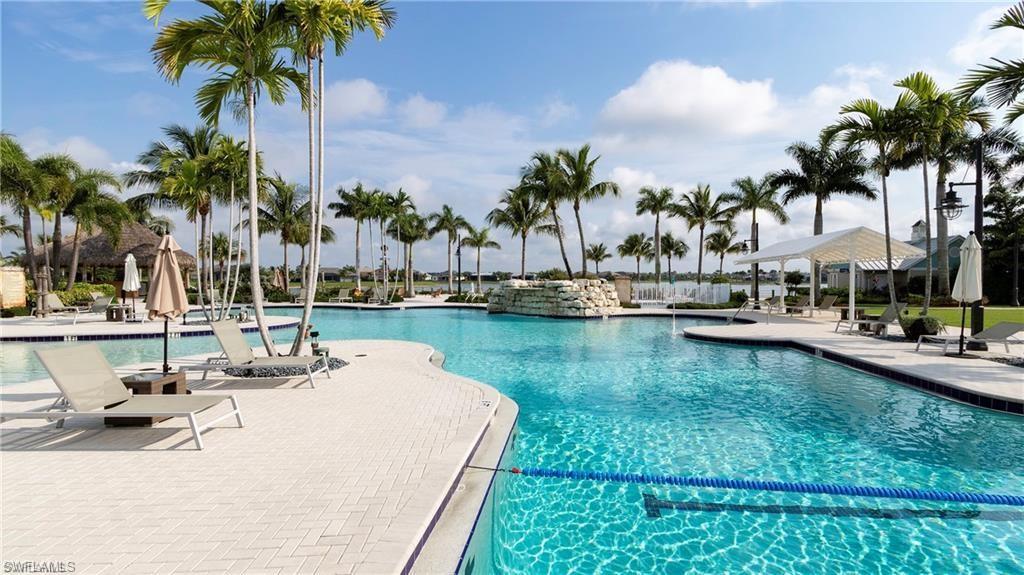 a view of swimming pool with a table and chairs