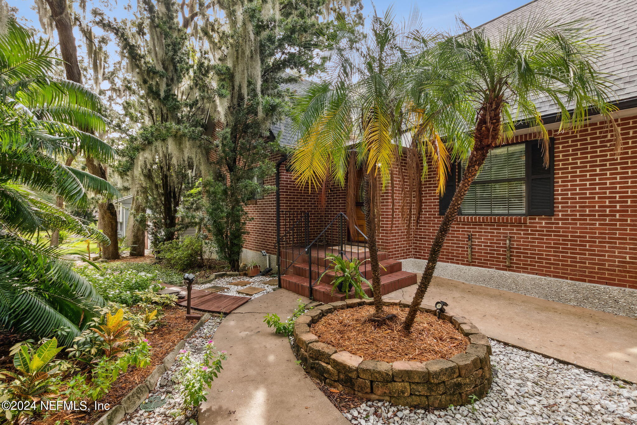 a view of a house with a tree in a yard