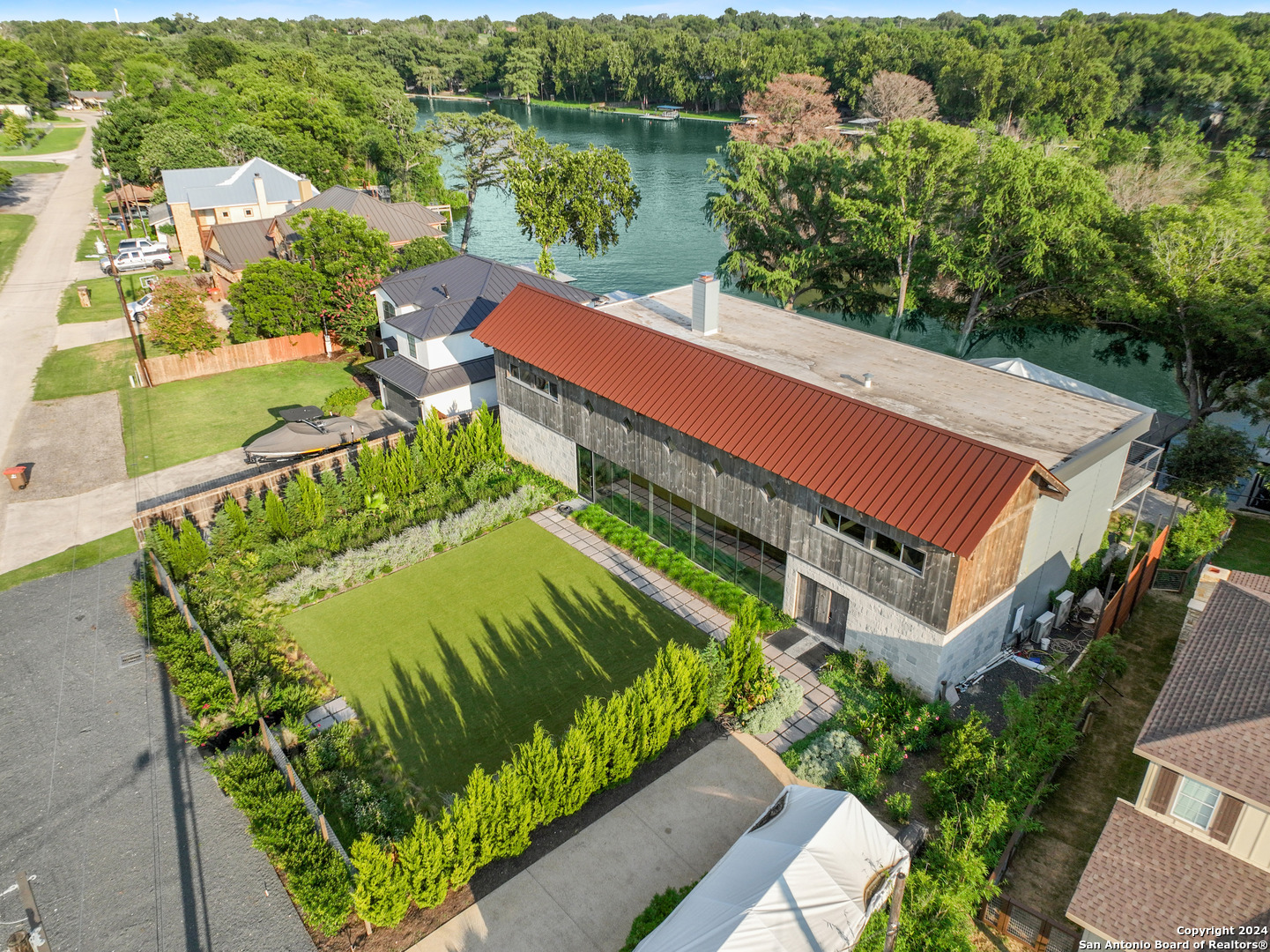 a view of a swimming pool with a garden and lake view