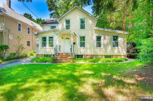 a front view of a house with a yard and porch