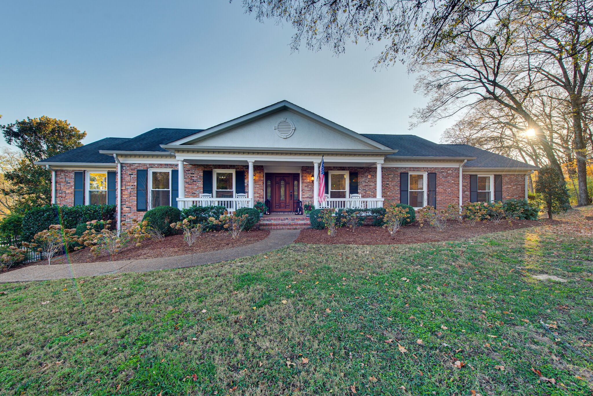 a front view of a house with yard and green space