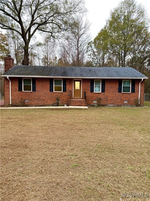 a front view of house with yard and trees around