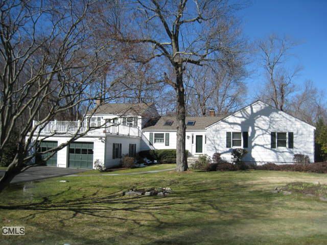 a front view of a house with a yard table and chairs