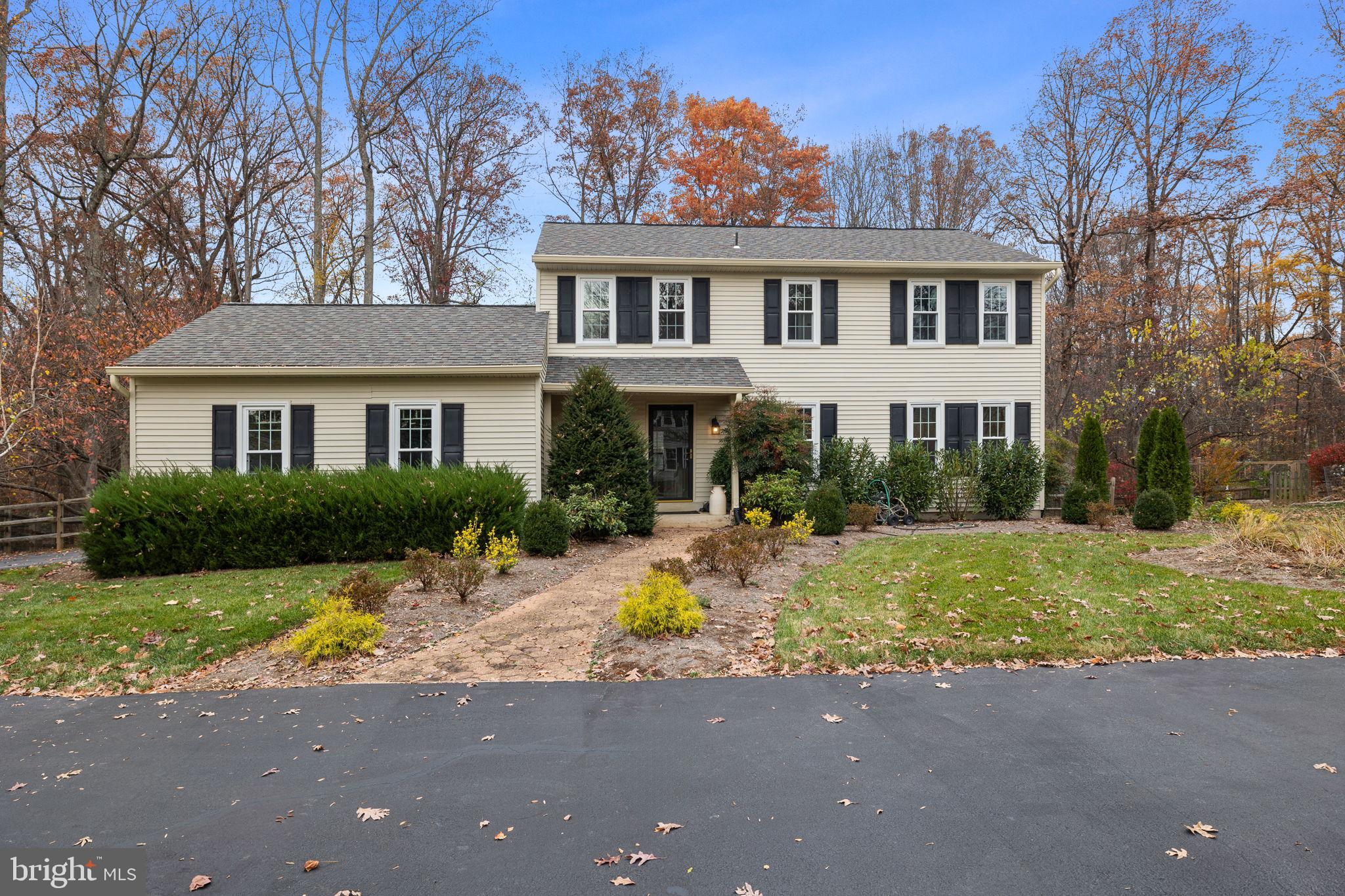 a front view of a house with swimming pool and porch