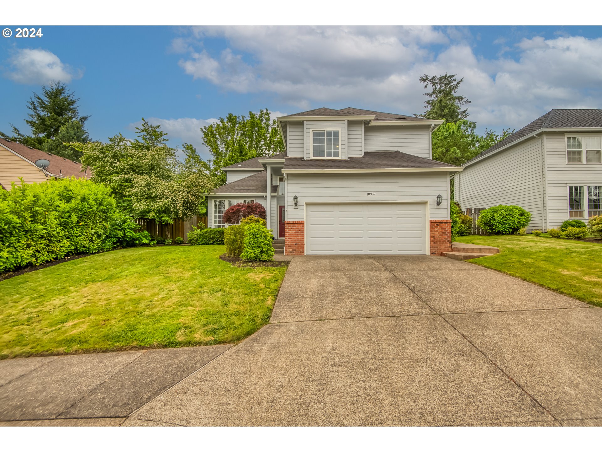 a front view of a house with a yard garage and outdoor seating